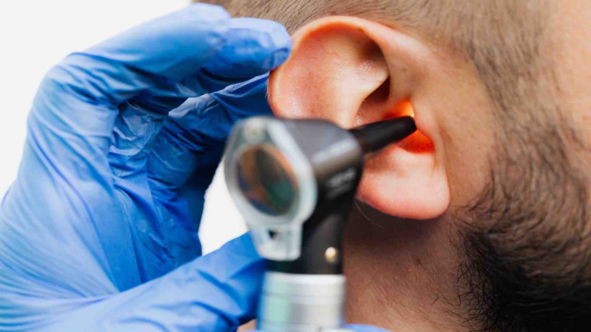Doctor examinating an ear