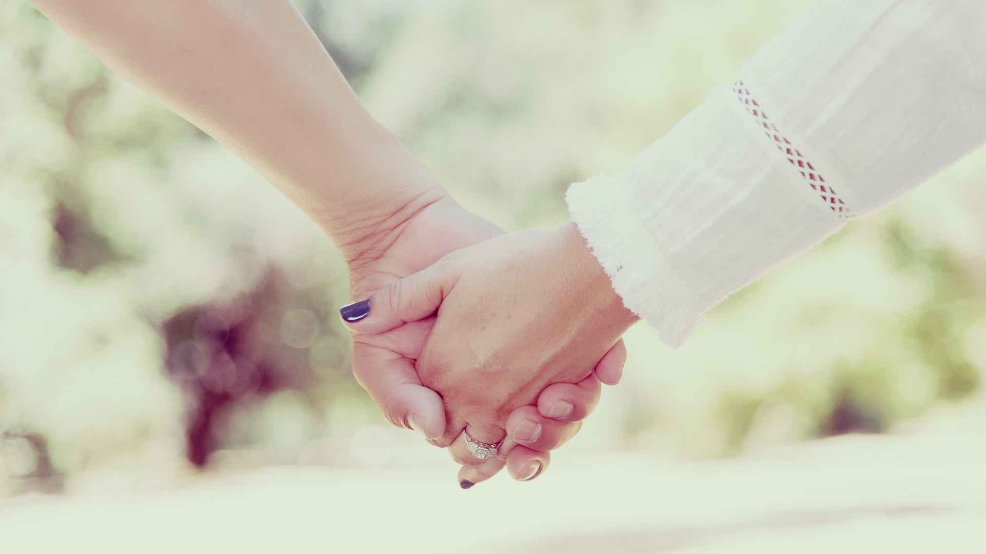 Two people holding hands